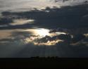 Sunset, trees protect a Kansas homestead from harsh winds